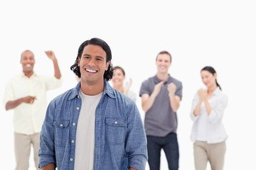 Fototapeta premium Close-up of a man laughing with people applauding