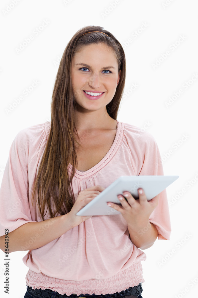 Poster close-up of a smiling girl using a touchpad