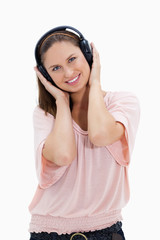 Smiling girl with pink shirt wearing headphones