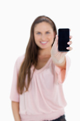 Close-up of a girl showing a smartphone screen