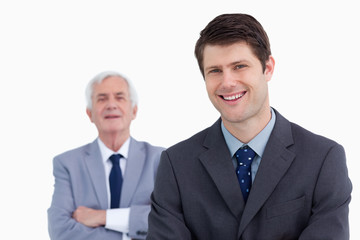 Close up of smiling businessman with his boss behind him