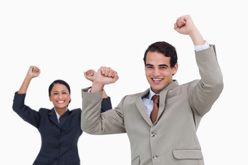 Celebrating salesman with colleague behind him