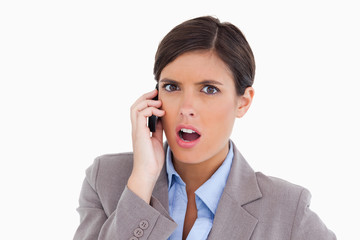 Close up of angry female entrepreneur on her cellphone