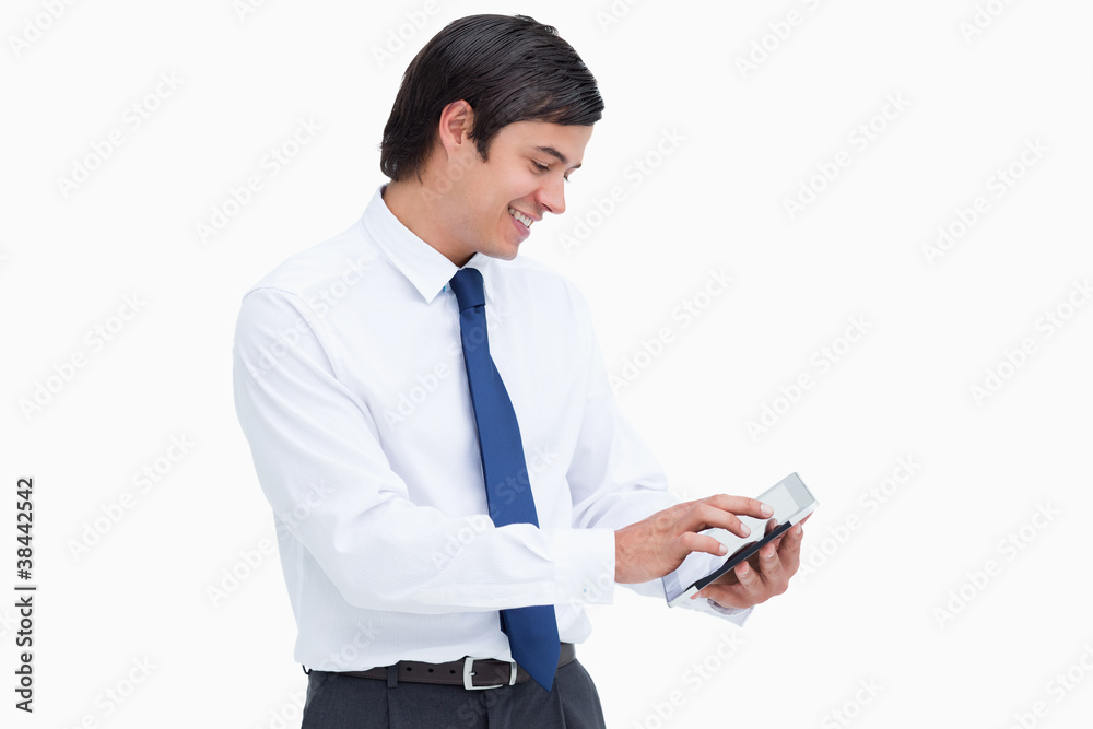 Poster Side view of smiling tradesman using his tablet computer