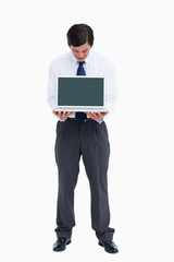 Tradesman looking at laptop screen he is presenting