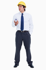 Young male architect with plans and helmet