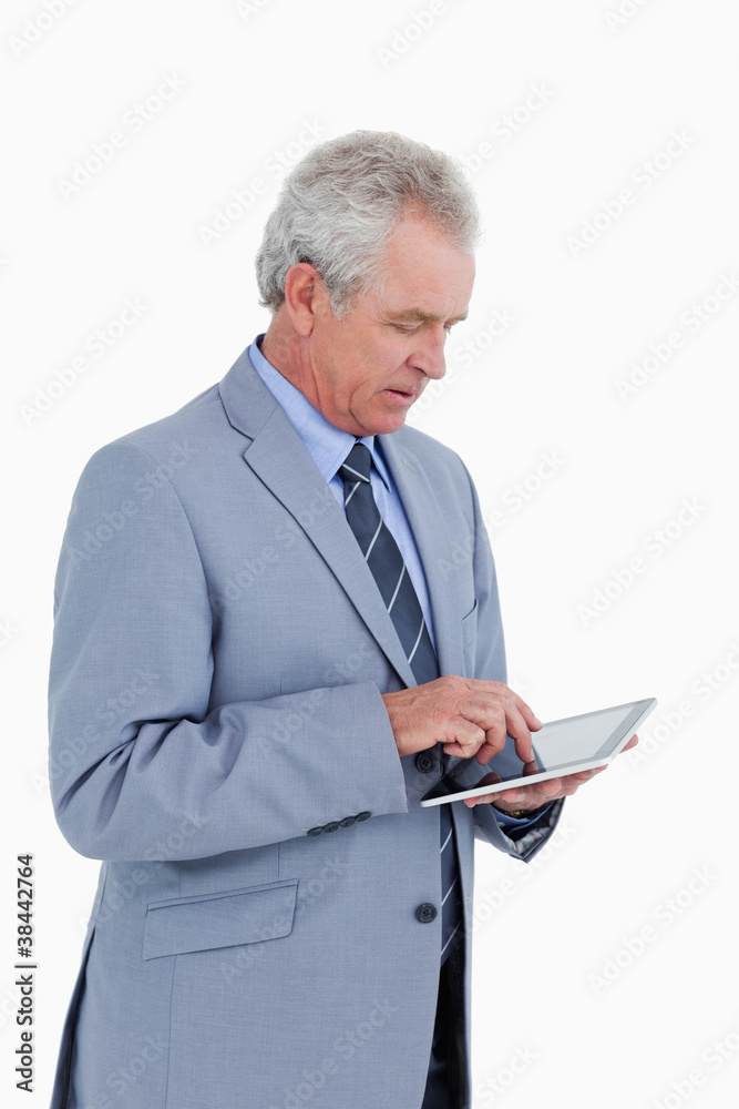 Poster Side view of mature tradesman using tablet computer