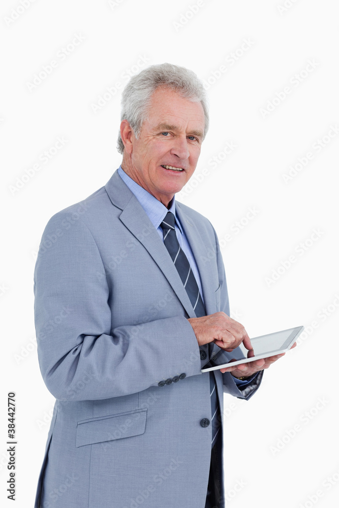 Poster side view of mature tradesman with tablet computer