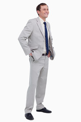 Smiling businessman with hands in his pockets