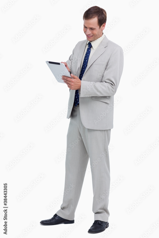 Poster Smiling businessman using tablet computer