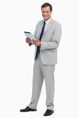 Obraz na płótnie Canvas Smiling businessman with his tablet computer