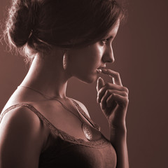 Portrait of a girl holding a finger around the lips