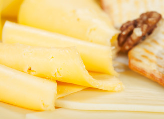 Various types of cheese on wooden platter