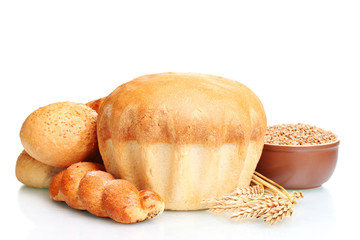 delicious round bread, buns and wheat isolated on white