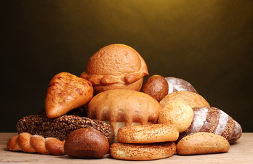 delicious bread on wooden table on brown background