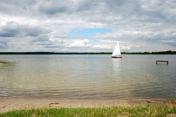 Sailing boat on the lake, amazing clouds © MartaSzloser
