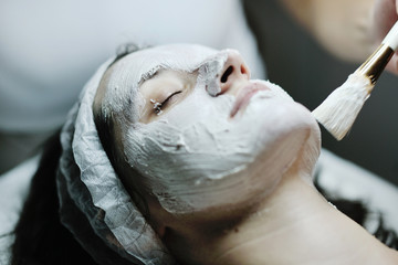 woman with facial mask in cosmetic studio
