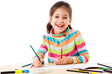 Smiling little girl draw with crayons