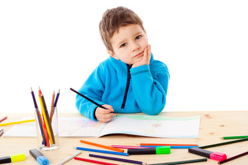 Little boy draw with crayons