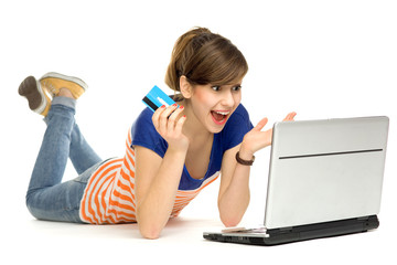 Surprised woman with credit card and laptop