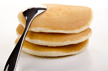 golden brown pancakes and a spoon