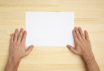 Fototapeta premium human hand holds a blank paper