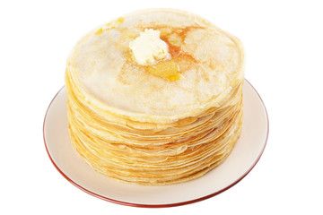 A stack of thin pancakes with butter