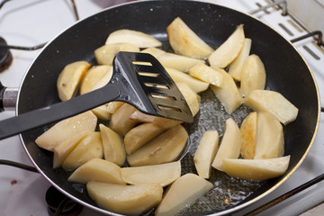 Fried potato on a frying pan