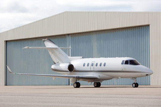 Airplane In Front Of Hangar