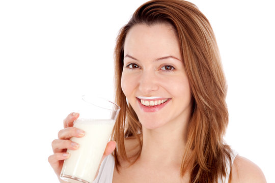 L&auml;chelnde junge Frau trink ein Glas Milch