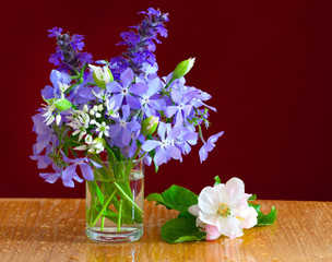 A bouquet of spring flowers in a glass
