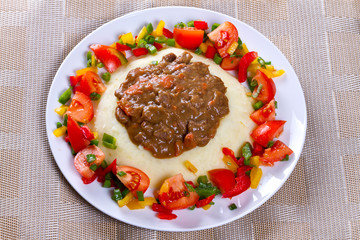 Beef goulash with potatoes and vegetables salad