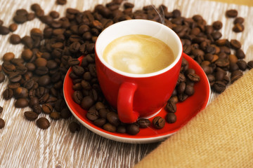Caffè in tazza rossa e chicchi