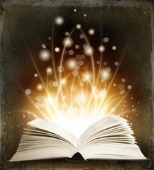 Open magic book on a dark background