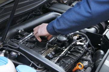 Fototapeta mechanic repairs a car in a garage obraz