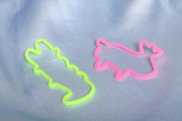 Pink and green Bracelets bandz with animals forms on blue tissu