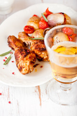 Roasted chicken legs and a glass of beer