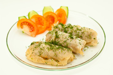 Stuffed cabbage on a plate against white