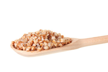 Wooden spoon with boiled buckwheat isolated on white