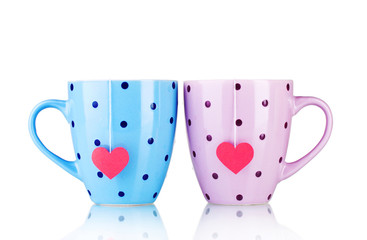 Two cups and tea bags with red heart-shaped label isolated