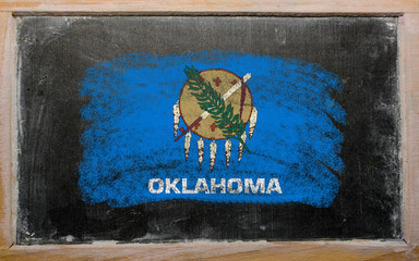 flag of US state of oklahoma on blackboard painted with chalk