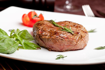 Grilled steak on a white plate