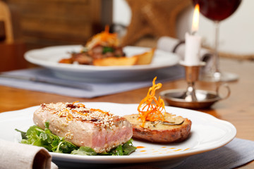 Fried tuna steak and potatoes on the plate