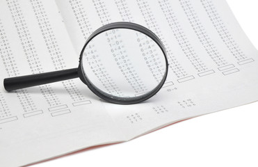 magnifying glass on a document with columns of figures
