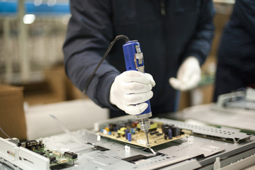 Close up of technician working on electronics