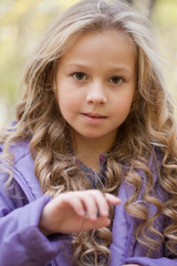 Fototapeta premium beautiful little girl on walk in autumn park