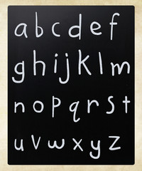 Complete english alphabet handwritten with white chalk