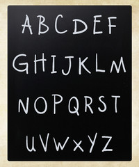 Complete english alphabet handwritten with white chalk