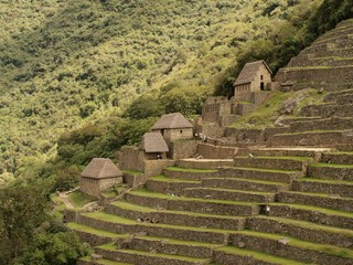 Inca terraces and huts in Machu Picchu town - obrazy, fototapety, plakaty
