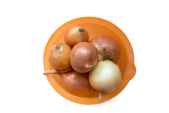 onion in an orange bowl on white background